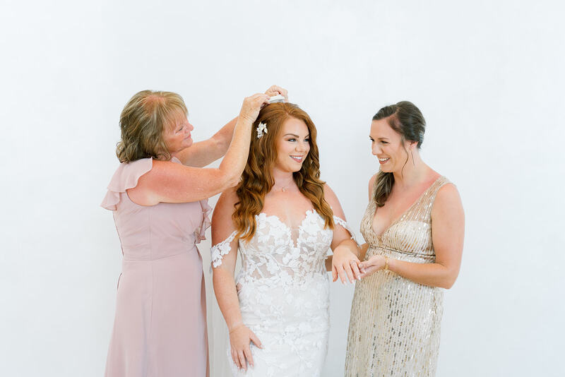Bridesmaids helping Kayla with wedding attire details