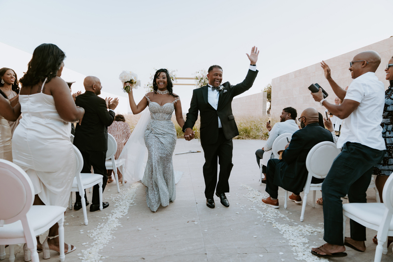 Guests cheering for Martin and Saleemah as they walk down the aisle