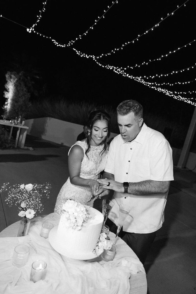 The couple cutting the cake
