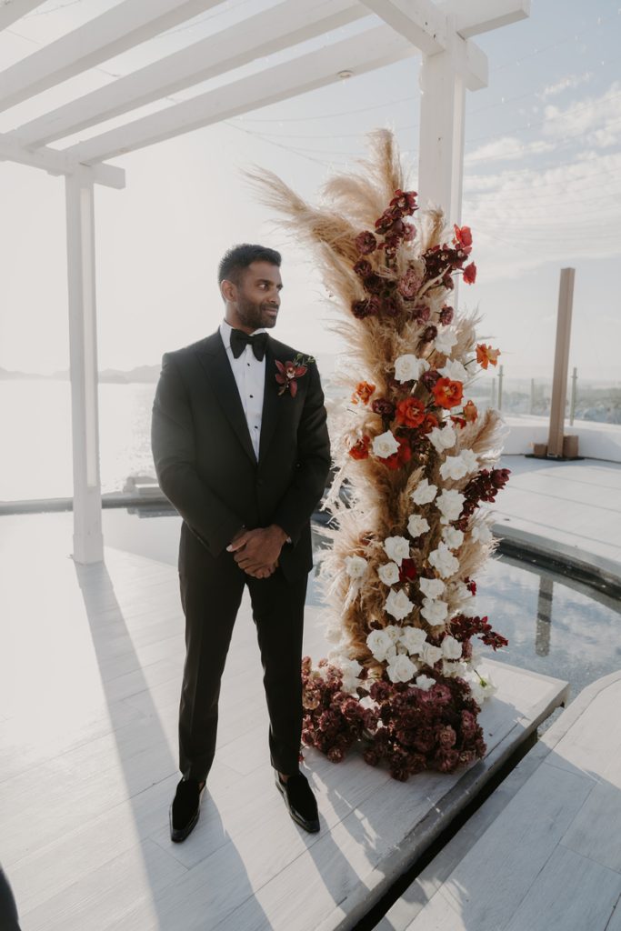 Jacob waiting for Viktorija by the Wedding Arch