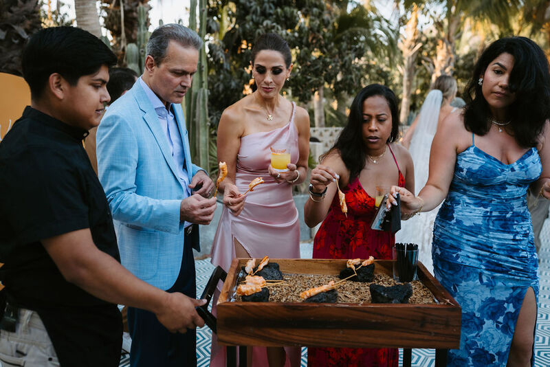 Guests enjoying shrimp skewers