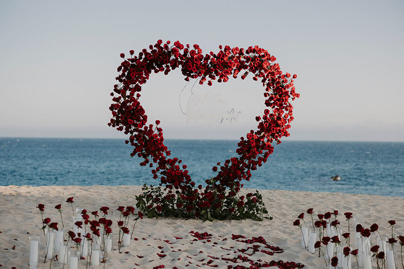 Heart made of roses placed in the beach for marriage proposal