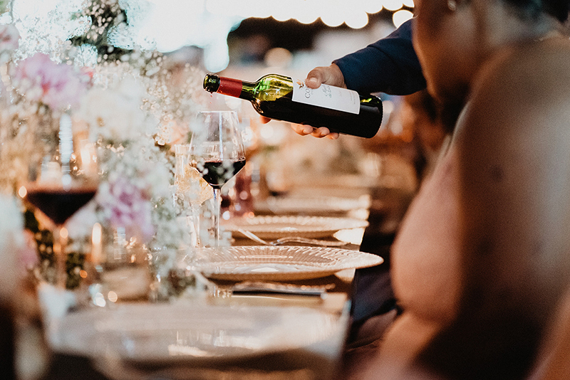 Waiter pouring wine