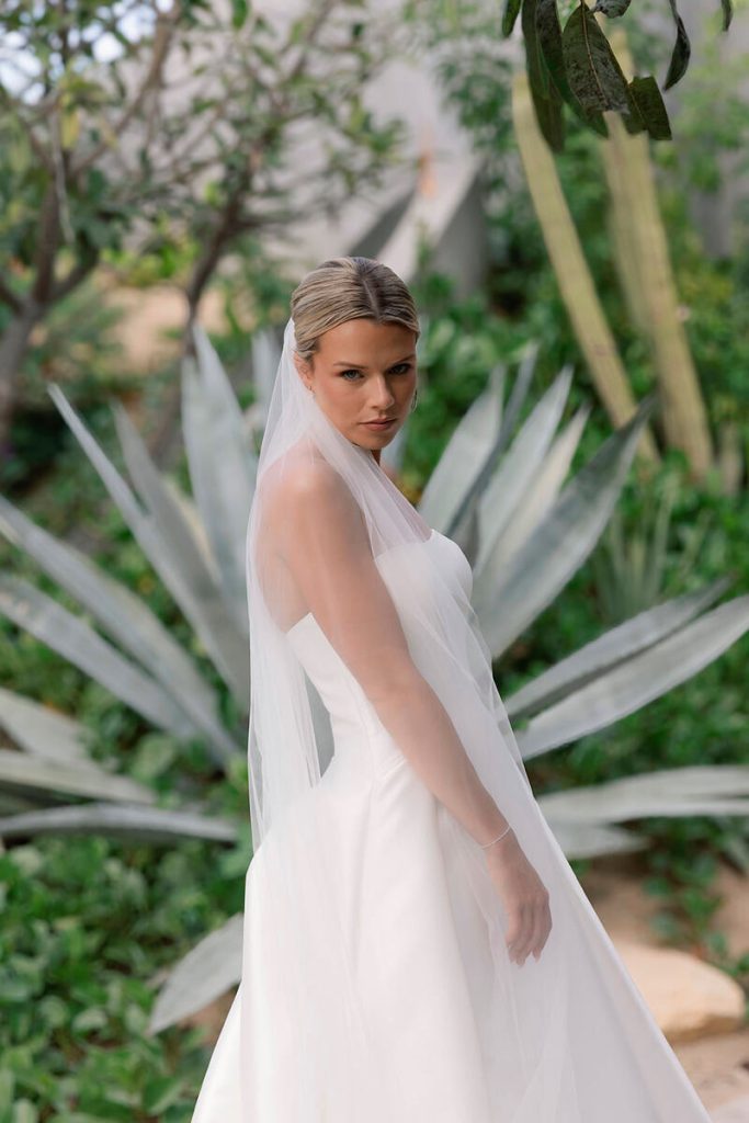 Bella posing for a portrait wearing her wedding dress