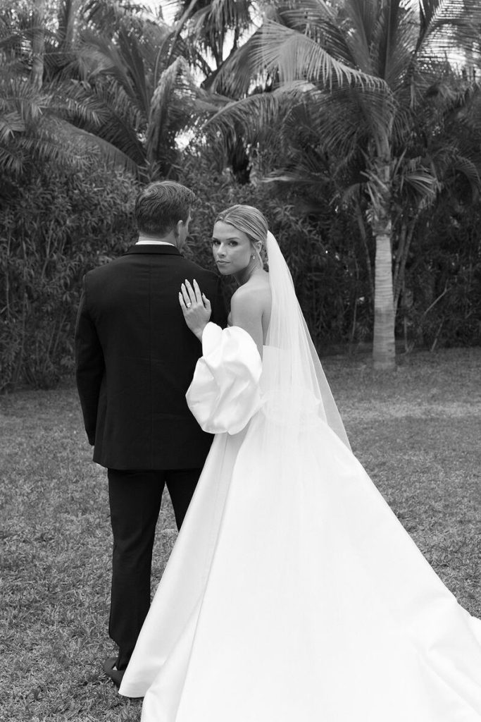 The newly weds walking through Acre gardens