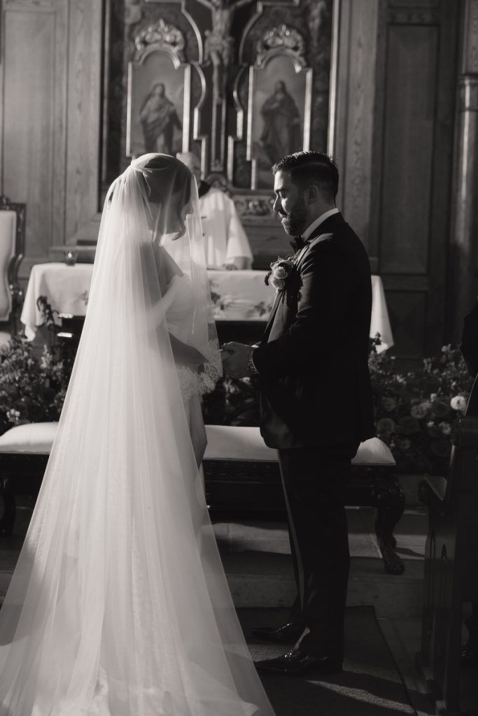 Eric putting the wedding ring on Courtney's finger